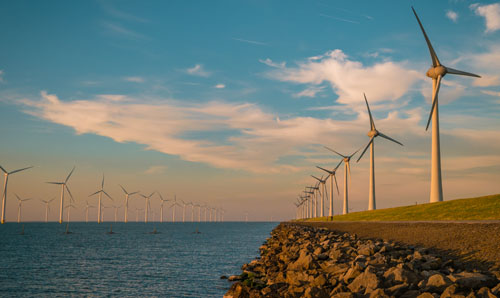 Wind power stations next to the sea.