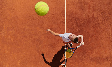 Professional tennis player serving the ball.
