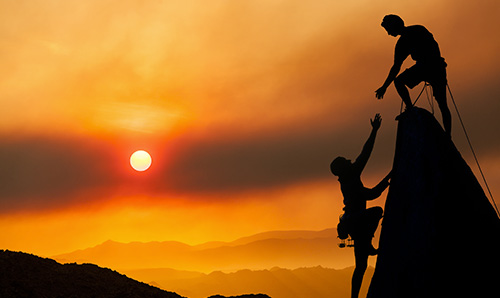 Climbers helping each other.