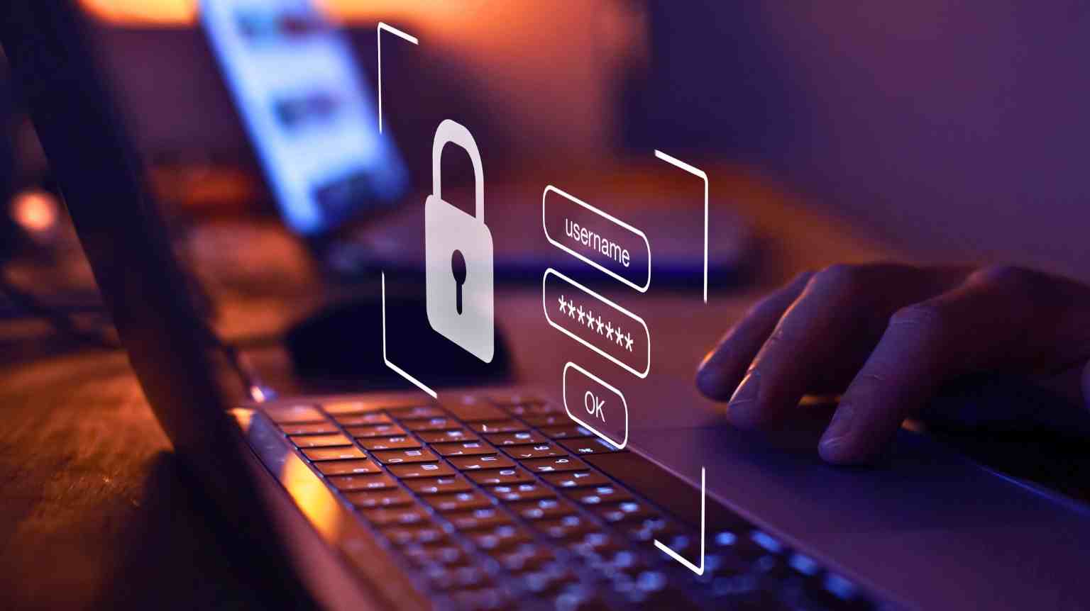 A silhouette of a person holding a camera, filming in a room lit with pink lighting.