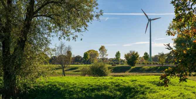 Wind turbine in a green countryside landscape. 